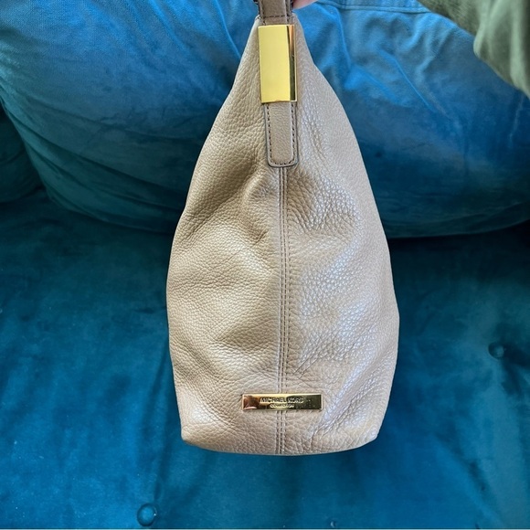 MICHAEL KORS COLLECTION
Skorpios Desert Tan Pebbled Leather Hobo
Bag $79… - Picture 7 of 16